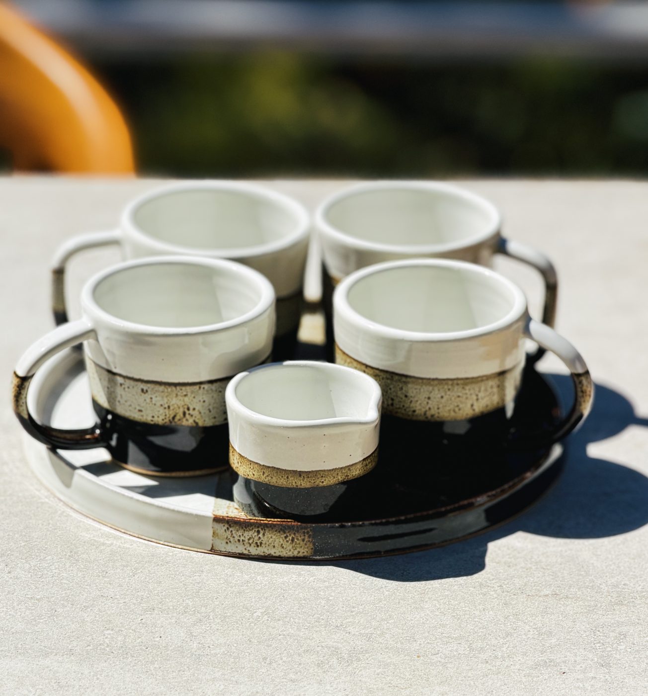 Stoneware 6 pieces: 4 mugs “Coffee and Cream” plus creamer and serving plate, handmade by Suzanne Luna