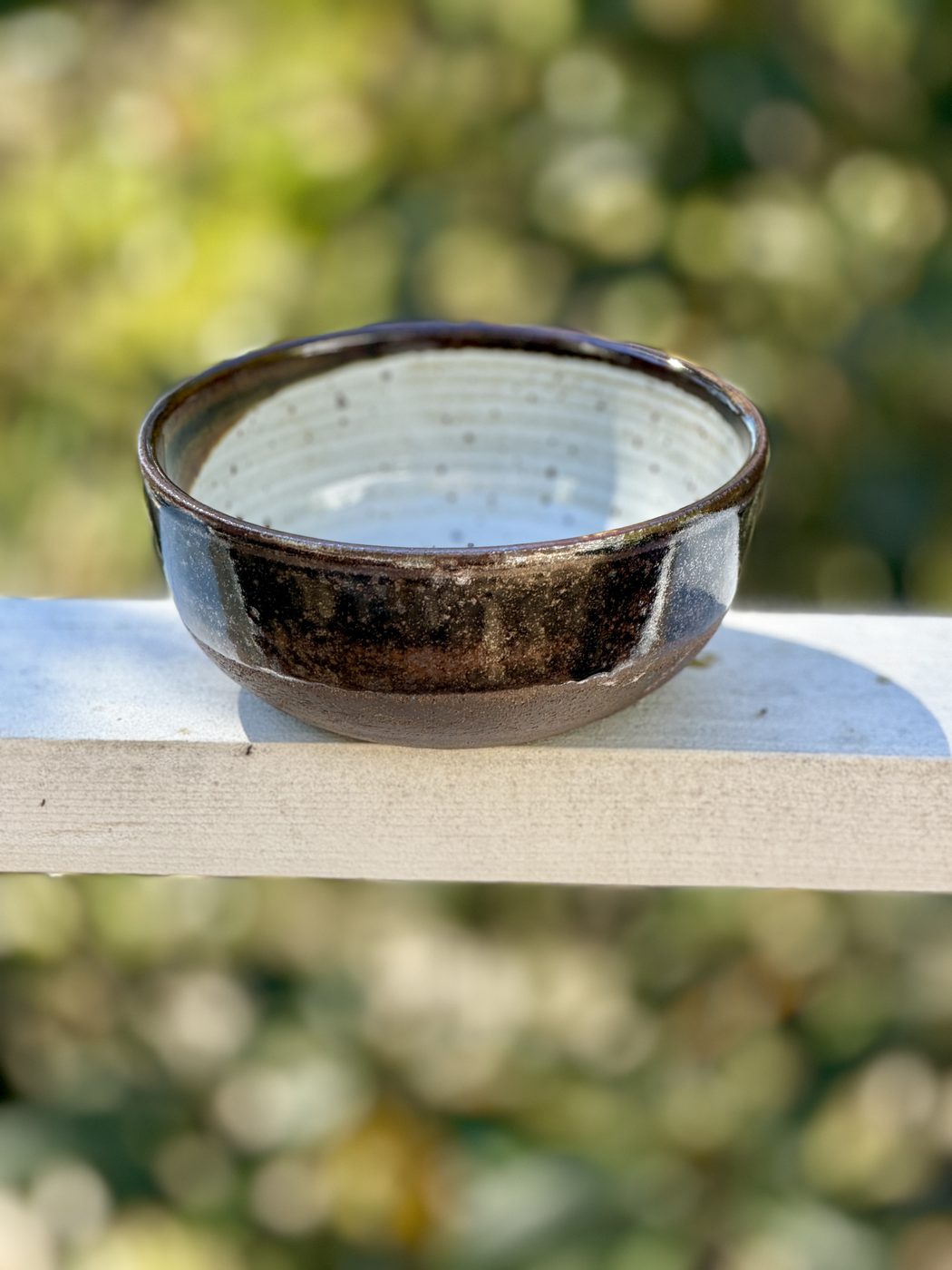 Stoneware medium White interior half brown half raw ext. black clay, handmade by Suzanne Luna