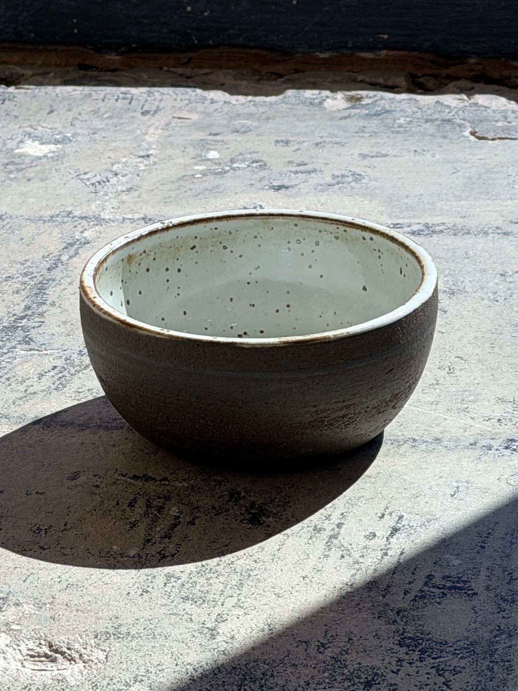 Stoneware medium White speckled int and raw black clay ext., handmade by Suzanne Luna